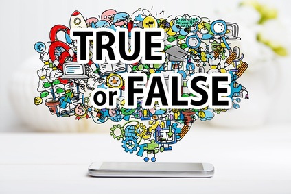 True or Fales concept with smartphone on white table