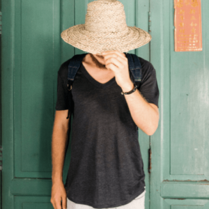 man wearing staw hat while travelling