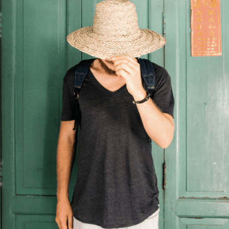 man wearing staw hat while travelling